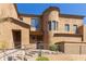 Lovely two-story stucco house featuring a tower, decorative tile roof, and attractive desert landscaping at 16600 N Thompson Peak Pkwy # 1072, Scottsdale, AZ 85260