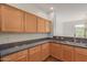 Bright kitchen features wood cabinets, granite countertops, and stainless steel sink at 16600 N Thompson Peak Pkwy # 1072, Scottsdale, AZ 85260
