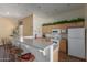 Community kitchen area with a bar and stools, a refrigerator, microwave, oven, and natural wood cabinets at 16600 N Thompson Peak Pkwy # 1072, Scottsdale, AZ 85260
