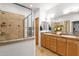 Bathroom with double sinks, wooden cabinets, granite countertops, and a glass enclosed shower at 17025 E La Montana Dr # 123, Fountain Hills, AZ 85268