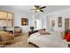 Bedroom with two windows, a ceiling fan and an en suite bathroom can be seen through the open door at 17025 E La Montana Dr # 123, Fountain Hills, AZ 85268