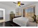 Bedroom with dark wood flooring, ceiling fan and plantation shutters with a view at 17025 E La Montana Dr # 123, Fountain Hills, AZ 85268