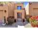 The front entrance gate leads to desert-style home with lush desert landscaping at 17025 E La Montana Dr # 123, Fountain Hills, AZ 85268
