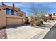 Beautiful two-story home featuring a tandem two car garage, balcony, and desert landscaping at 17025 E La Montana Dr # 123, Fountain Hills, AZ 85268