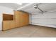 Spacious garage with ample storage cabinets, pegboard, and a white garage door with automatic opener at 17025 E La Montana Dr # 123, Fountain Hills, AZ 85268
