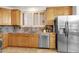 Spacious kitchen features stainless steel appliances, light wood cabinets, and tiled backsplash at 17025 E La Montana Dr # 123, Fountain Hills, AZ 85268