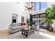 Bright living room with vaulted ceilings, modern furnishings, and a sliding glass door to the patio at 17025 E La Montana Dr # 123, Fountain Hills, AZ 85268
