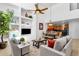 Bright, open-plan living room with built-in shelving, tile flooring, and an adjacent dining area and kitchen at 17025 E La Montana Dr # 123, Fountain Hills, AZ 85268
