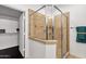 Shower stall with glass door and a view into the walk-in closet with lots of shelving at 17025 E La Montana Dr # 123, Fountain Hills, AZ 85268