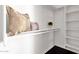 Walk-in closet with white shelves and dark hardwood flooring at 17025 E La Montana Dr # 123, Fountain Hills, AZ 85268