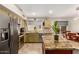 Well-lit kitchen with stainless steel appliances, granite countertops, and a dining table with seating for six at 1741 S Clearview Ave # 70, Mesa, AZ 85209