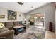 Bright living room with large sectional, neutral walls, a sliding glass door, and views to the outdoor space at 1741 S Clearview Ave # 70, Mesa, AZ 85209