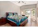 Spacious main bedroom with ceiling fan, large windows to the pool area, and a comfortable king bed at 1741 S Clearview Ave # 70, Mesa, AZ 85209
