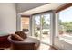 Bright sitting area that overlooks the pool area, featuring sliding glass doors and a comfortable chaise lounge at 1741 S Clearview Ave # 70, Mesa, AZ 85209