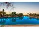 Scenic waterfront view with lush landscaping and tranquil blue water reflecting the serene sky at 1741 S Clearview Ave # 70, Mesa, AZ 85209