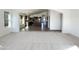 Bright, open-concept living area with sightlines to the kitchen and dining area at 17494 N Maddaloni Ave, Maricopa, AZ 85138