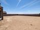 A large backyard with new construction, and clear blue skies, presents a blank canvas at 17621 W Pierson St, Goodyear, AZ 85395