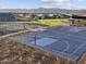 Outdoor basketball court with pristine surface, hoop, and mountain backdrop, located in a well-maintained recreation area at 17621 W Pierson St, Goodyear, AZ 85395