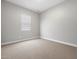 Cozy, carpeted bedroom with a window, offering a simple and comfortable space at 17621 W Pierson St, Goodyear, AZ 85395