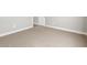 Spacious bedroom with neutral carpet and a white door, ready for personalization at 17621 W Pierson St, Goodyear, AZ 85395