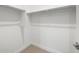 A walk-in closet with carpet and built-in shelving offers an abundance of storage at 17621 W Pierson St, Goodyear, AZ 85395