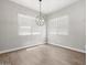 Dining room featuring tile flooring, neutral walls, and modern light fixture at 17621 W Pierson St, Goodyear, AZ 85395