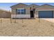 Single-story home featuring a desert-landscaped front yard, blue garage door, and shutters at 17621 W Pierson St, Goodyear, AZ 85395