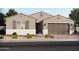 Charming single-story home featuring desert landscaping, a neutral color palette, and an attached two-car garage at 17621 W Pierson St, Goodyear, AZ 85395