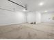 A spacious garage with clean floors, and overhead lighting ready for vehicles and storage at 17621 W Pierson St, Goodyear, AZ 85395