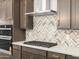 Modern kitchen with sleek appliances, stylish backsplash, and custom cabinetry at 17621 W Pierson St, Goodyear, AZ 85395