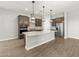Spacious kitchen with a large center island, stainless steel appliances, and stylish pendant lights at 17621 W Pierson St, Goodyear, AZ 85395