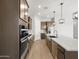 Modern kitchen featuring stainless steel appliances, quartz counters and wood-look flooring at 17621 W Pierson St, Goodyear, AZ 85395