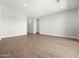 An empty living room showcasing clean, neutral walls and new tile flooring at 17621 W Pierson St, Goodyear, AZ 85395