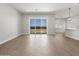 Spacious living room featuring tile flooring, an open layout, and natural light through a sliding glass door at 17621 W Pierson St, Goodyear, AZ 85395