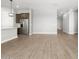 Living room showcasing tile flooring and an open layout into kitchen with stainless steel appliances at 17621 W Pierson St, Goodyear, AZ 85395