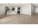 Living room with tile flooring flowing into an open kitchen area with stainless steel refrigerator at 17621 W Pierson St, Goodyear, AZ 85395