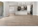 Living room showcasing sleek tile flooring, open layout, and modern finishes, flowing seamlessly into the kitchen at 17621 W Pierson St, Goodyear, AZ 85395