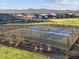 Outdoor pickleball courts with fencing, providing a great recreational amenity for residents with mountain views at 17621 W Pierson St, Goodyear, AZ 85395