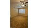 This is a bright bedroom with a ceiling fan, neutral walls, and carpeted floors at 1825 W Ray Rd # 1058, Chandler, AZ 85224