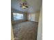 Well-lit living room features a ceiling fan and neutral colored carpeting at 1825 W Ray Rd # 1058, Chandler, AZ 85224