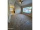 Spacious living room features a ceiling fan and a large window at 1825 W Ray Rd # 1058, Chandler, AZ 85224