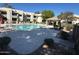 A community pool provides outdoor recreation with chairs, landscaping, and a shaded ramada at 1825 W Ray Rd # 1058, Chandler, AZ 85224