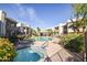 Inviting community pool with mature landscaping, seating, spa, and well-maintained exteriors at 1825 W Ray Rd # 1058, Chandler, AZ 85224