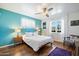 Stylish bedroom with wood floors, bright blue accent wall, and large window at 1939 E Solano Dr, Phoenix, AZ 85016