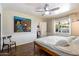 Bright bedroom features wood floors, updated window, ensuite bathroom, and modern ceiling fan at 1939 E Solano Dr, Phoenix, AZ 85016