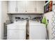 Convenient laundry room with washer, dryer, storage cabinets and modern design at 1939 E Solano Dr, Phoenix, AZ 85016