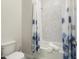 Bright bathroom with shower and tub featuring patterned tile and modern shower curtain at 21387 W Meadowbrook Ave, Buckeye, AZ 85396
