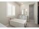 Bright bathroom with a soaking tub and walk-in shower, enhanced by natural light at 21387 W Meadowbrook Ave, Buckeye, AZ 85396
