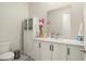 Bright powder room with white cabinet vanity, quartz countertops, and modern mirror at 21387 W Meadowbrook Ave, Buckeye, AZ 85396