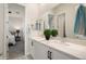 This bathroom features double sinks and a view into the bedroom at 21387 W Meadowbrook Ave, Buckeye, AZ 85396